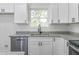 Modern kitchen features stainless steel appliances, granite countertops, and white cabinetry at 620 Gilmer St, Burlington, NC 27217