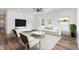 Bright living room with modern decor, stylish seating, and a large screen TV for entertainment at 620 Gilmer St, Burlington, NC 27217