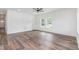 Open-concept living room with wood-look flooring, ceiling fan, and lots of natural light at 620 Gilmer St, Burlington, NC 27217