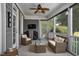 Relaxing back porch with comfortable wicker seating, ceiling fan, and screened-in design at 6489 Waters Edge Dr, Rocky Mount, NC 27803