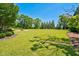 Expansive backyard with lush green lawn, mature trees, and plenty of space for outdoor activities at 6489 Waters Edge Dr, Rocky Mount, NC 27803
