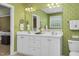 Bathroom featuring double vanity, large mirror and leaf-motif wallpaper at 6489 Waters Edge Dr, Rocky Mount, NC 27803