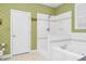 Bathroom featuring a walk-in shower, garden tub and white tile and leaf-motif wallpaper at 6489 Waters Edge Dr, Rocky Mount, NC 27803