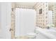 Cozy bathroom with white vanity, shower with a white curtain, and wallpaper with blue sailboats at 6489 Waters Edge Dr, Rocky Mount, NC 27803