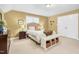 This bedroom has neutral walls and carpet with a bench with storage at the end of the bed at 6489 Waters Edge Dr, Rocky Mount, NC 27803