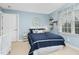 Light blue bedroom features a navy quilt-covered bed, bright natural light and a whimsical décor at 6489 Waters Edge Dr, Rocky Mount, NC 27803