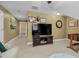Bonus room featuring a mounted TV, beige carpet, and doorway leading to the staircase at 6489 Waters Edge Dr, Rocky Mount, NC 27803
