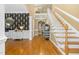 Elegant foyer with hardwood floors, staircase, and stylish wallpaper at 6489 Waters Edge Dr, Rocky Mount, NC 27803