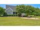 Beautifully landscaped home exterior with a well-maintained lawn, mature trees, and charming curb appeal at 6489 Waters Edge Dr, Rocky Mount, NC 27803