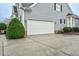 A well-maintained home featuring an attached two-car garage with a large concrete driveway at 6489 Waters Edge Dr, Rocky Mount, NC 27803
