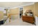 Hallway features a table with lamp and decor, carpeted floor and railing overlooking the entryway at 6489 Waters Edge Dr, Rocky Mount, NC 27803