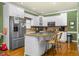 This kitchen boasts stainless steel appliances, white cabinets, and large island with seating at 6489 Waters Edge Dr, Rocky Mount, NC 27803
