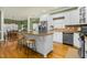 Kitchen features a large island with seating, stainless steel appliances, and white cabinets at 6489 Waters Edge Dr, Rocky Mount, NC 27803