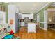 Bright kitchen features white cabinets, stainless steel appliances, and a large island with breakfast bar at 6489 Waters Edge Dr, Rocky Mount, NC 27803