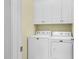 A laundry room is shown with white cabinets above a white washer and dryer at 6489 Waters Edge Dr, Rocky Mount, NC 27803