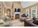 Comfortable living room featuring a fireplace, vaulted ceiling, and an open concept design to the kitchen at 6489 Waters Edge Dr, Rocky Mount, NC 27803