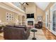 Open-concept living room boasts a vaulted ceiling, fireplace, hardwood floors, and second story view at 6489 Waters Edge Dr, Rocky Mount, NC 27803