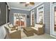 Relaxing outdoor patio with wicker furniture and view into the dining room at 6489 Waters Edge Dr, Rocky Mount, NC 27803