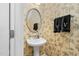 Chic powder room featuring palm print wallpaper, pedestal sink, and stylish mirror at 6489 Waters Edge Dr, Rocky Mount, NC 27803