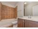 Well-lit bathroom features a tub with a shower and a vanity with modern fixtures at 700 Finsbury St # 304, Durham, NC 27703