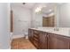 Spacious bathroom featuring dual sinks, tile floor, a bathtub with shower, and a large mirror at 700 Finsbury St # 304, Durham, NC 27703