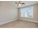 Neutral bedroom with a large window providing ample natural light and a ceiling fan at 700 Finsbury St # 304, Durham, NC 27703