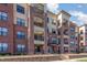 Attractive red brick apartment building with black wrought iron balconies and manicured landscaping at 700 Finsbury St # 304, Durham, NC 27703
