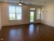 Spacious living room featuring hardwood floors, a ceiling fan and bright light from a patio door at 700 Finsbury St # 304, Durham, NC 27703
