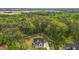 Aerial shot of home surrounded by lush green trees, and an extended driveway for multiple vehicles at 80 Carnation Rd, Youngsville, NC 27596