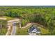 Aerial view of home surrounded by green trees and a large, manicured lawn in a tranquil environment at 80 Carnation Rd, Youngsville, NC 27596