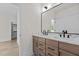 Bright bathroom with a double vanity sink and large mirror at 80 Carnation Rd, Youngsville, NC 27596