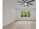 Spacious bedroom featuring a decorative ceiling, stylish millwork, and a large window with views of the trees at 80 Carnation Rd, Youngsville, NC 27596