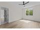 Bright bedroom with wood-look flooring, a window, and ceiling fan for comfort at 80 Carnation Rd, Youngsville, NC 27596
