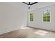 Bright, empty bedroom with two windows and ceiling fan at 80 Carnation Rd, Youngsville, NC 27596