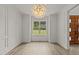 Bright dining room featuring wood floors, decorative molding, and a modern chandelier at 80 Carnation Rd, Youngsville, NC 27596