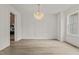Dining room with modern chandelier, decorative white walls, and adjacent to the kitchen at 80 Carnation Rd, Youngsville, NC 27596