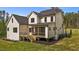 Wide view of the back exterior and porch with stairs leading to the home's large green backyard at 80 Carnation Rd, Youngsville, NC 27596