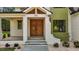 Close-up of the front entrance with a modern wood door and stylish white brick pillars at 80 Carnation Rd, Youngsville, NC 27596