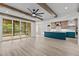 Modern kitchen with a blue island, stainless steel appliances, hardwood cabinets, and a sliding glass door to the porch at 80 Carnation Rd, Youngsville, NC 27596