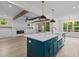 Open-concept kitchen with a large island, farmhouse sink, and a clear view of the living room at 80 Carnation Rd, Youngsville, NC 27596