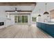 Open floor plan with living room, dining area, and kitchen with an island and a sliding glass door to the porch at 80 Carnation Rd, Youngsville, NC 27596
