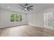 Main bedroom featuring stylish millwork, a ceiling fan, a large window with tree views, and an ensuite bathroom at 80 Carnation Rd, Youngsville, NC 27596