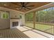 Inviting screened-in porch with a cozy fireplace and wood ceiling at 80 Carnation Rd, Youngsville, NC 27596