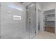 Beautiful tile shower featuring a glass door, bronze fixtures, and mosaic tile flooring at 80 Carnation Rd, Youngsville, NC 27596