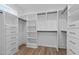 Spacious walk-in closet features custom shelving, drawers, and hanging rods for optimal organization at 80 Carnation Rd, Youngsville, NC 27596