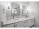 Bathroom with double sinks, white cabinets, and large mirrors at 917 S Blount St, Raleigh, NC 27601