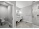 Bright bathroom featuring double sinks with marble countertops and a walk-in shower with glass door at 917 S Blount St, Raleigh, NC 27601
