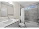 Bright bathroom with marble tile in shower/tub, featuring a modern vanity and fixtures at 917 S Blount St, Raleigh, NC 27601
