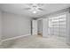Bedroom with neutral walls and carpet floors, with an open closet with wooden railing at 917 S Blount St, Raleigh, NC 27601