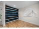 Cozy bedroom featuring custom blue wall shelving and lots of natural light at 917 S Blount St, Raleigh, NC 27601